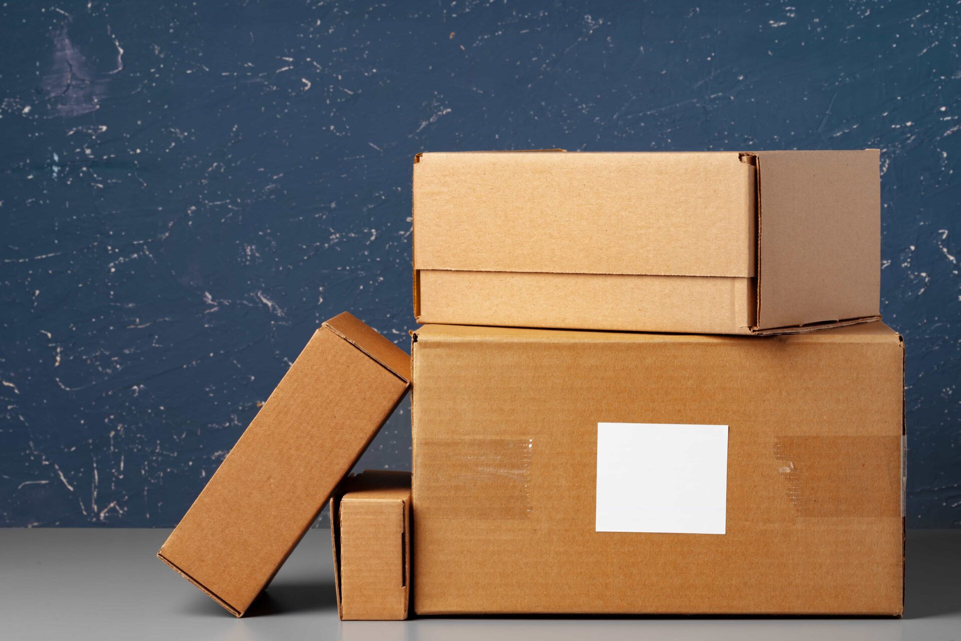 Group of cardboard boxes against blue background 2025 02 25 05 49 58 utc